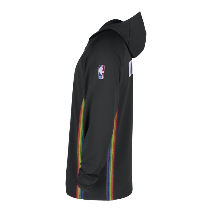 Side profile view of the black performance hooded jacket. This angle highlights the continuous, vibrant vertical rainbow stripe pattern cutting straight down the side seam. The red, white, and blue NBA logo patch is visible on the upper arm, and the slight texturing of the grey lettering on the back panel peeks out from the right edge