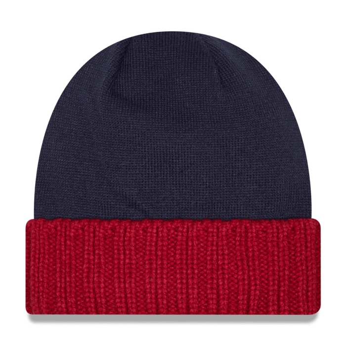 Back view of the navy blue knit beanie, displaying the solid navy crown and the plain red folded cuff.