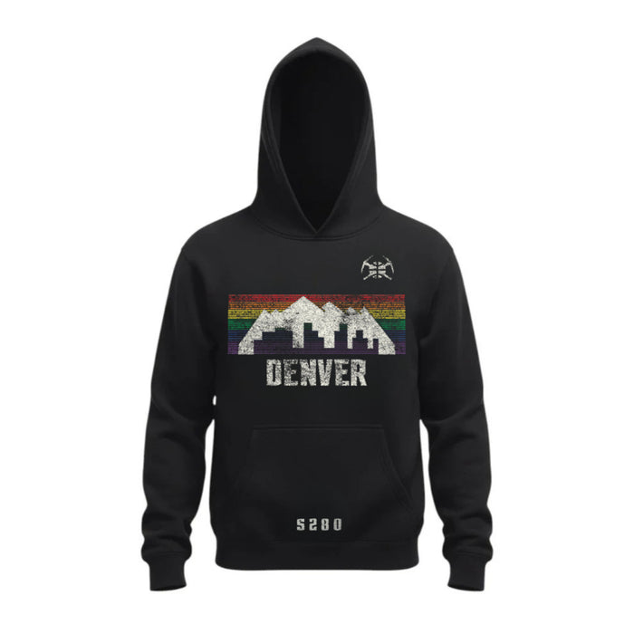 A black pullover hoody displayed against a white background. The chest features a retro Denver graphic with a white mountain silhouette and city skyline overlaying a horizontal rainbow striped band. Directly below the graphic, the word 'DENVER' is printed in a white distressed font. A small white pickaxe logo sits on the left chest, and small block text is centered near the bottom hem