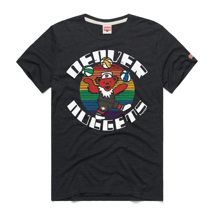 A black short-sleeve crewneck t-shirt featuring a retro mashup graphic on the center chest. The design features a cartoon Grateful Dead dancing bear wearing a basketball jersey and shorts, juggling three multi-colored basketballs. The character stands against a circular background filled with horizontal rainbow stripes. The team name 'DENVER NUGGETS' frames the graphic, with 'DENVER' arching across the top and 'NUGGETS' curving along the bottom in a white, retro block font. A tiny red brand logo