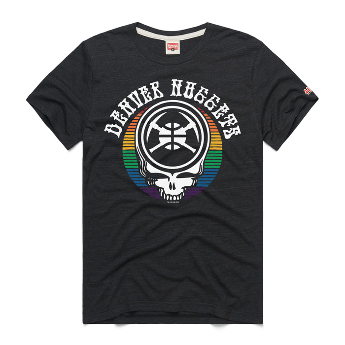 A black short-sleeve crewneck t-shirt featuring a hybrid music-and-sports graphic on the center chest. The design features a Grateful Dead 'Steal Your Face' style skull over a circular background filled with horizontal rainbow stripes. The skull's forehead contains a stylized circular emblem with a basketball and crossed white pickaxes. Arcing over the entire graphic is the team name 'DENVER NUGGETS' printed in a white, retro western-style block font. A tiny red brand logo is visible on the left