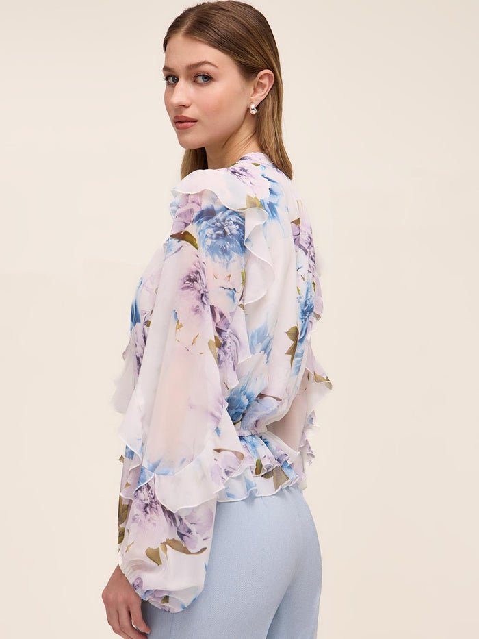 Floral peplum blouse with ruffle details and elasticized waist by Le Chateau.