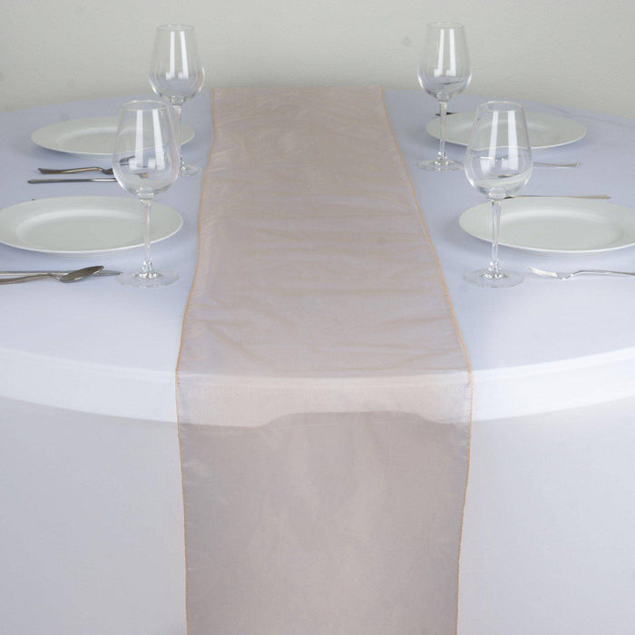 Elegant beige table runner on a round table set for dining. #whtbkgd