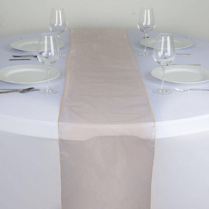 Elegant beige table runner on a round table set for dining. #whtbkgd