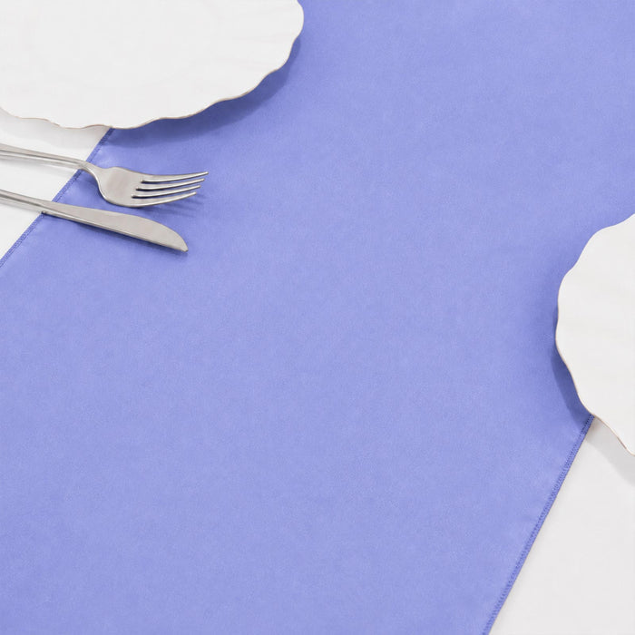 Lavender tablecloth with silver fork and knife on white tableware