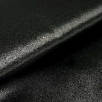 Black satin fabric with a smooth, glossy finish. #whtbkgd