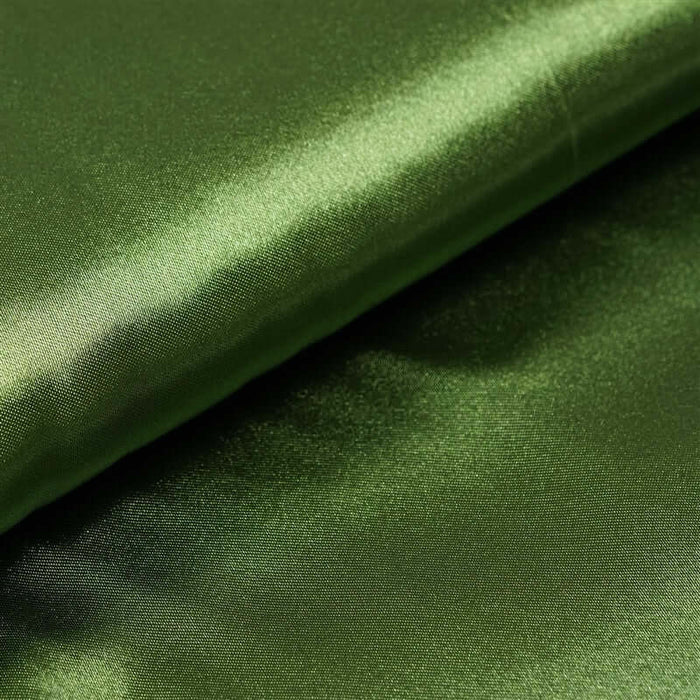 Shiny green fabric folded, showcasing its smooth texture. #whtbkgd