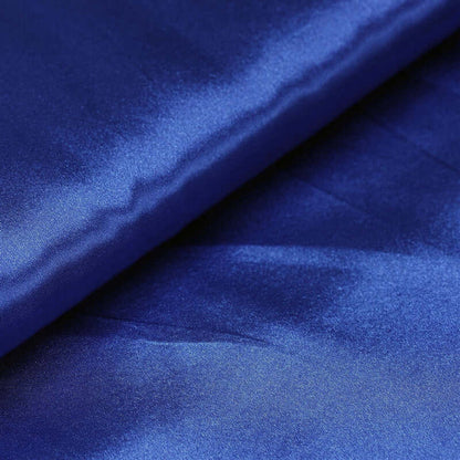 Royal blue satin fabric draped elegantly with a smooth finish. #whtbkgd