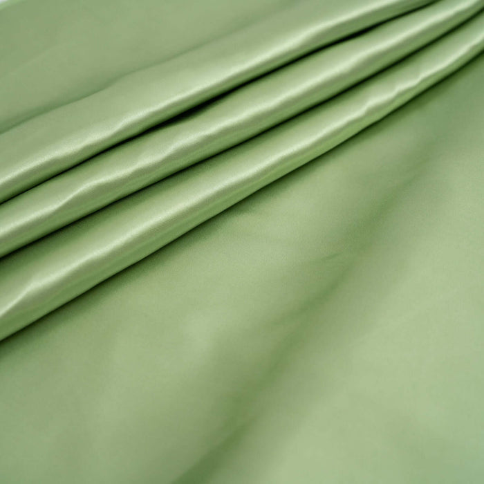 Smooth green fabric with gentle folds and a soft sheen.