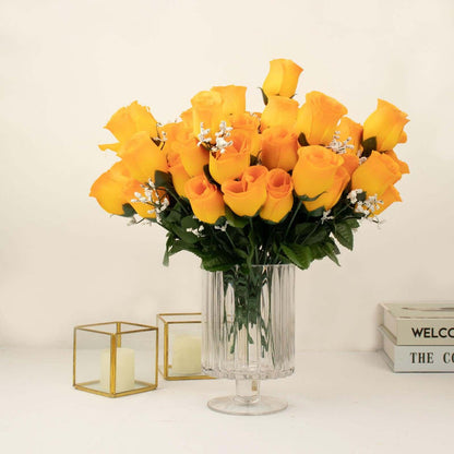 Bouquet of vibrant yellow roses in a clear vase on a white background