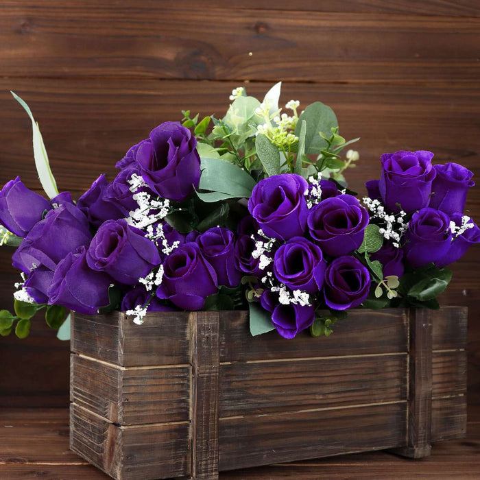 Purple rose bouquet in rustic wooden planter.