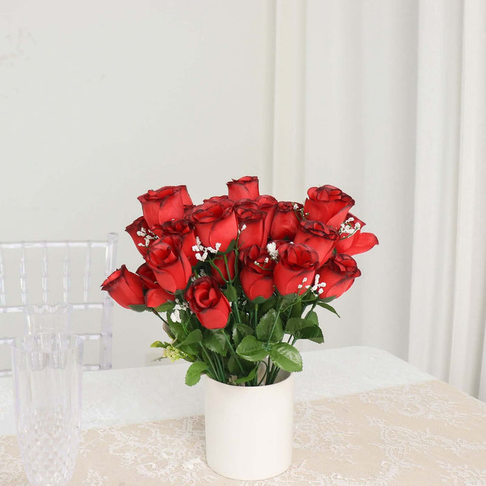 Bouquet of vibrant red roses in a white vase on a table