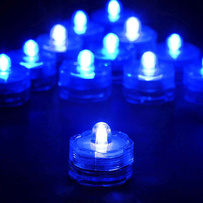 Blue LED tealight candles glowing in a dark setting.