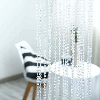 Transparent beaded curtain with blurred chair and table background.