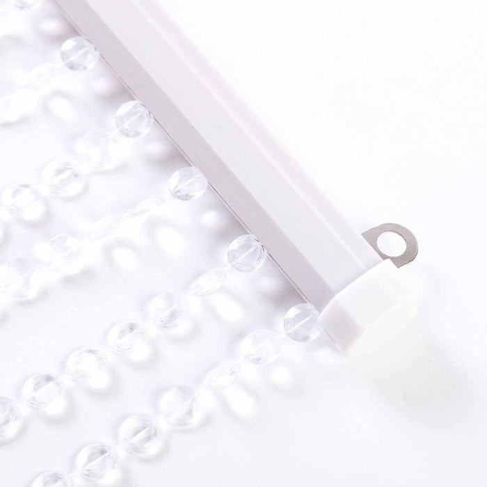 Clear acrylic curtain beads on a white background