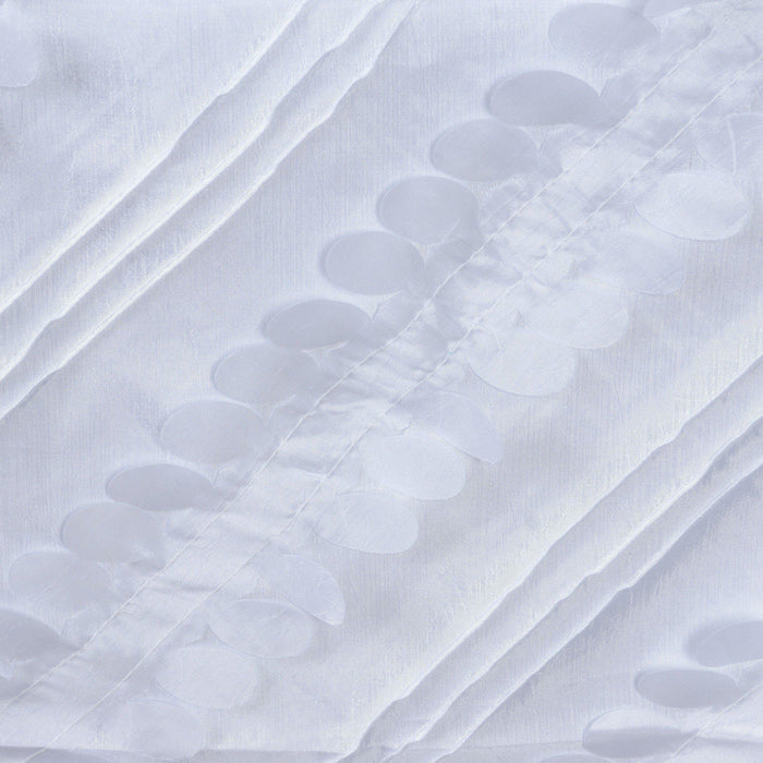 White fabric with raised circular patterns creating a textured design.