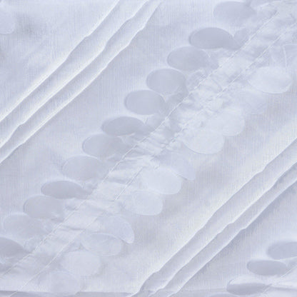 White fabric with raised circular patterns creating a textured design.