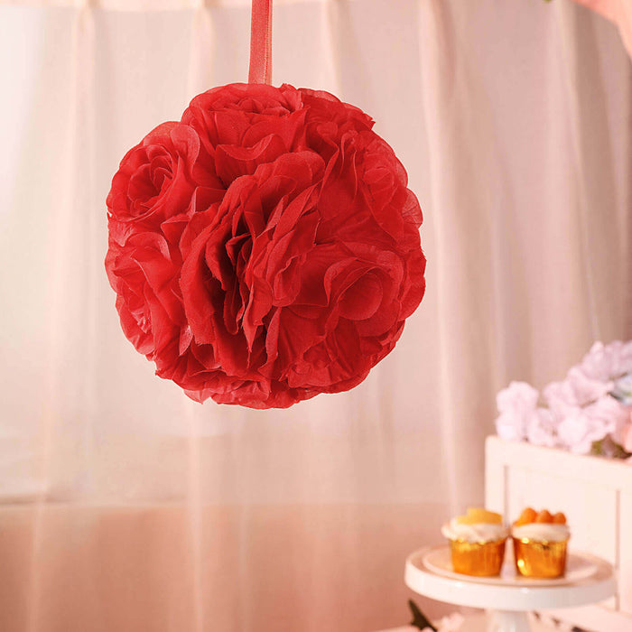 Red floral paper pom pom decoration hanging at a festive event.