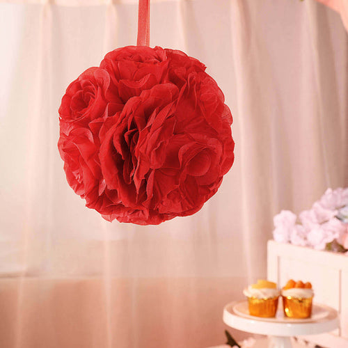 Red floral paper pom pom decoration hanging at a festive event.