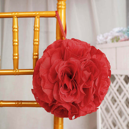 Red fabric flower decoration hanging on a golden chair.
