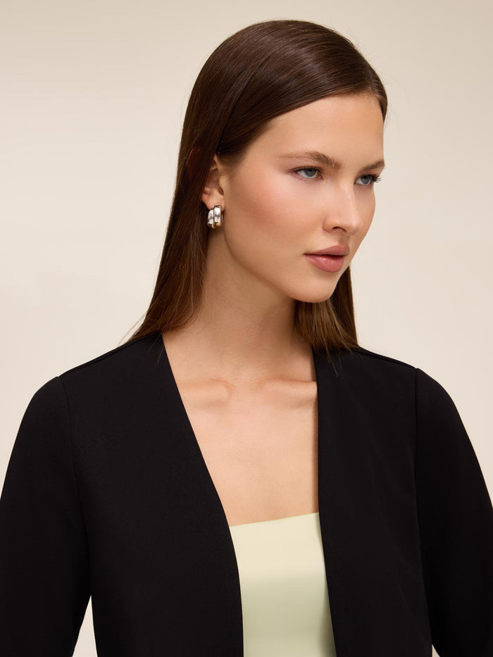 Knit crepe bolero with 3/4 sleeves and open-front design by Le Chateau.