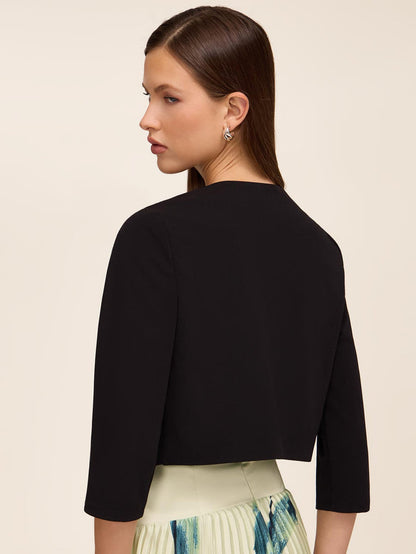 Knit crepe bolero with 3/4 sleeves and open-front design by Le Chateau.