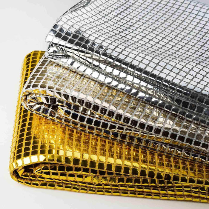 Shiny metallic table covers in silver, gold, and black stacked neatly.