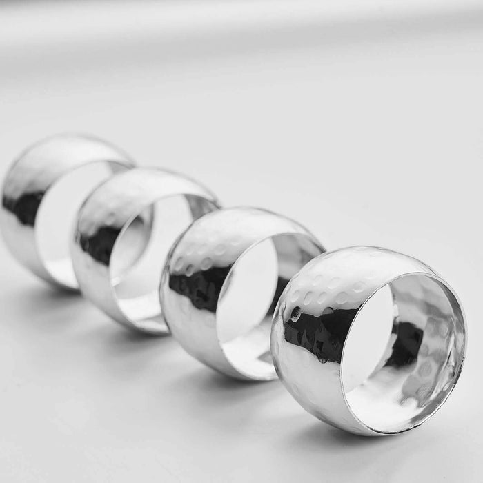 Set of four polished silver napkin rings #whtbkgd