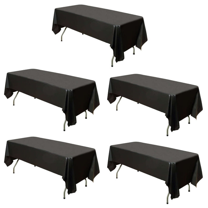 Set of five black table covers on plain background
