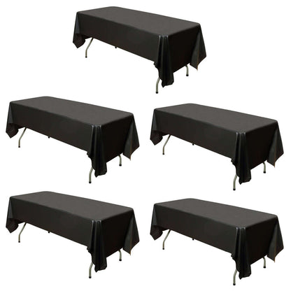 Set of five black table covers on plain background
