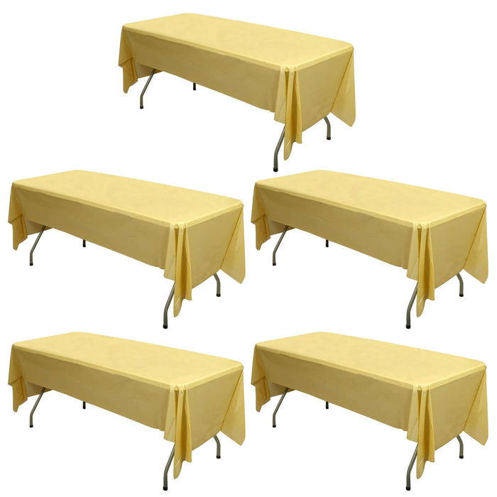 Yellow tablecloths on folding tables, ideal for events and gatherings.