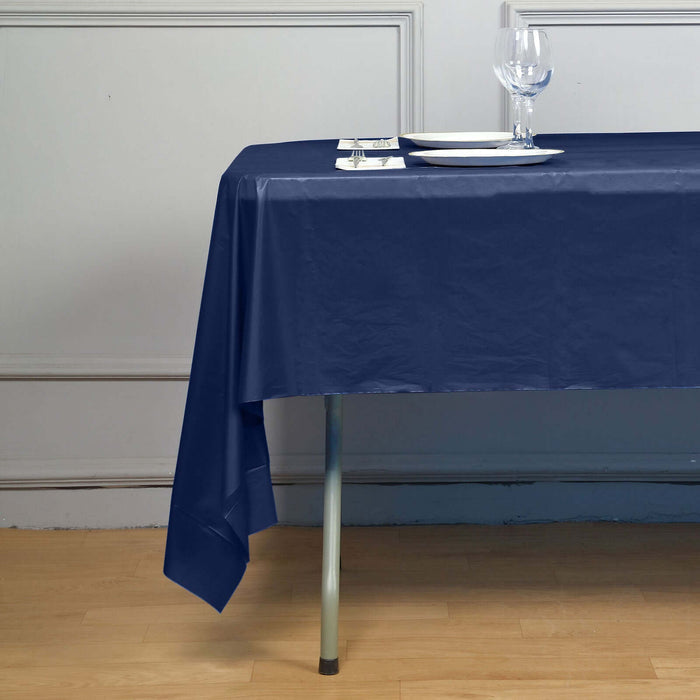 Navy blue tablecloth draped over a dining table setting.