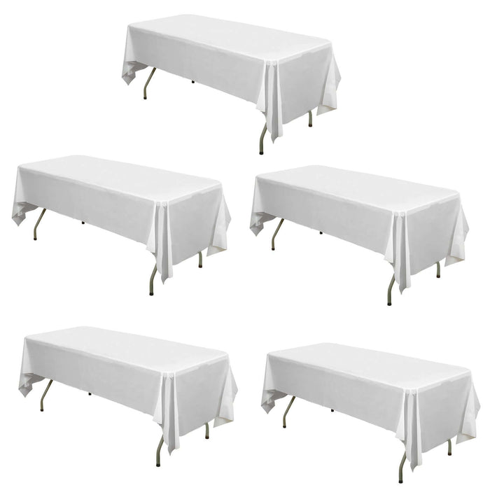 Set of five white table covers on folding tables