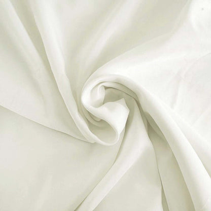 Soft white fabric draped elegantly, showcasing its smooth texture. #whtbkgd