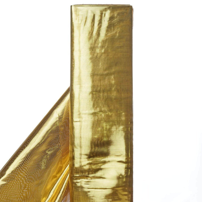 Gold metallic foil roll on a white backdrop