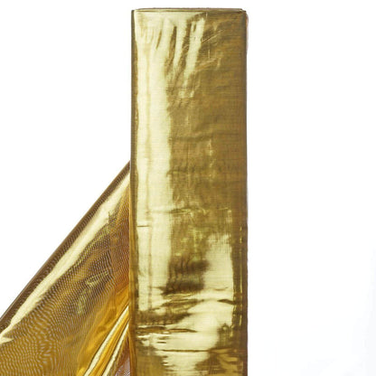 Gold metallic foil roll on a white backdrop