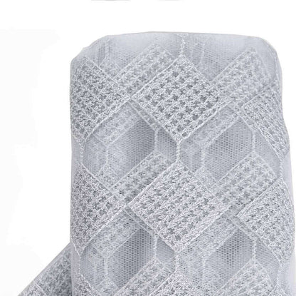 Gray lace fabric roll with geometric pattern on white backdrop
