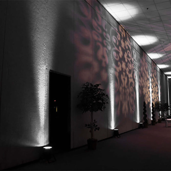 Decorative wall lighting with shadows in an indoor venue setting.