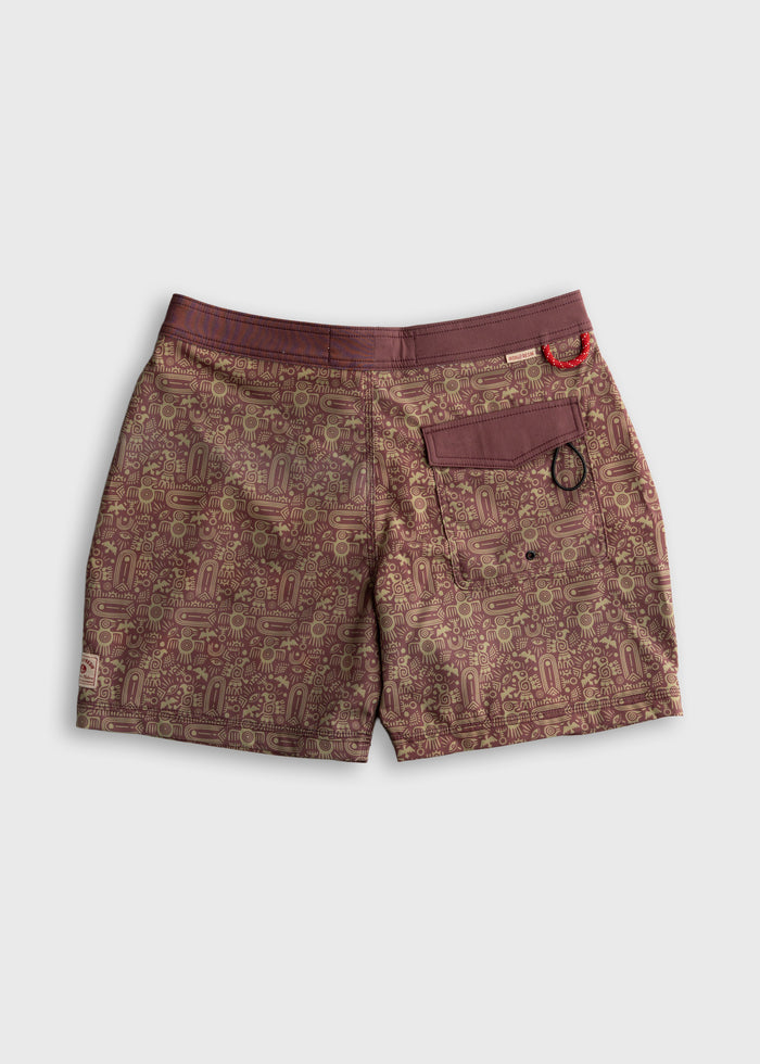 Brown shorts with intricate geometric patterns and a back pocket, featuring a small red loop detail on the waistband.