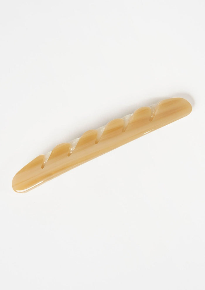A baguette hair clip in light brown.