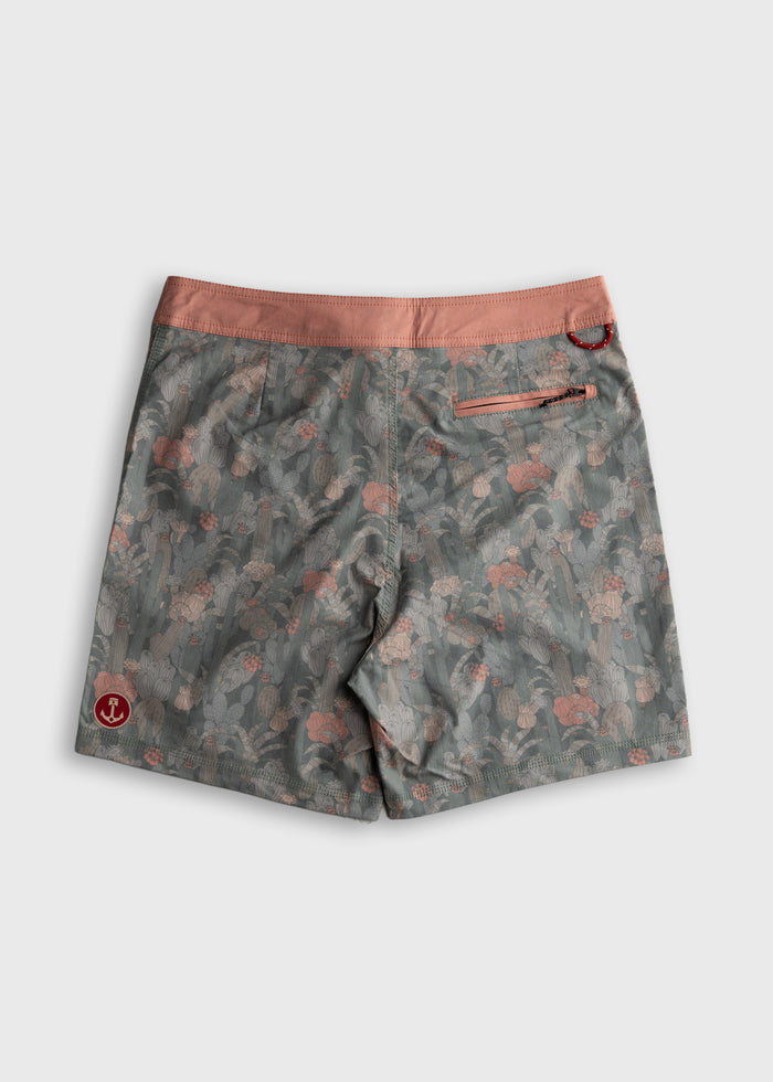 Gray floral-patterned shorts with a pink waistband and back pocket, featuring a small red logo on the lower left side.