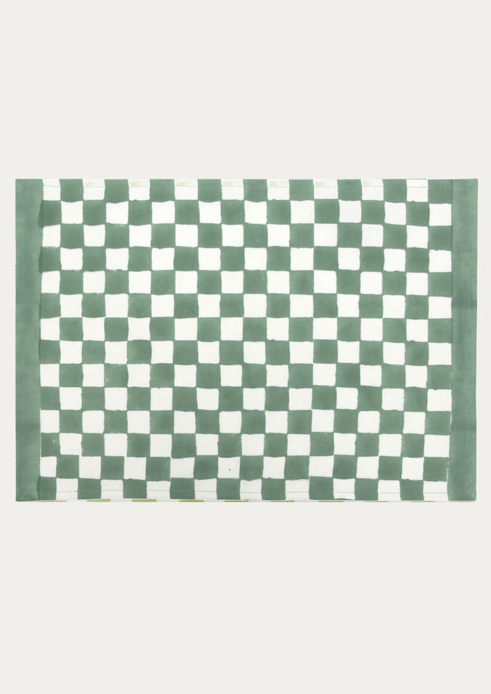 A block printed placemat with checkered pattern in clover green.