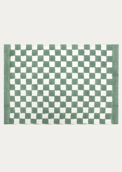 A block printed placemat with checkered pattern in clover green.