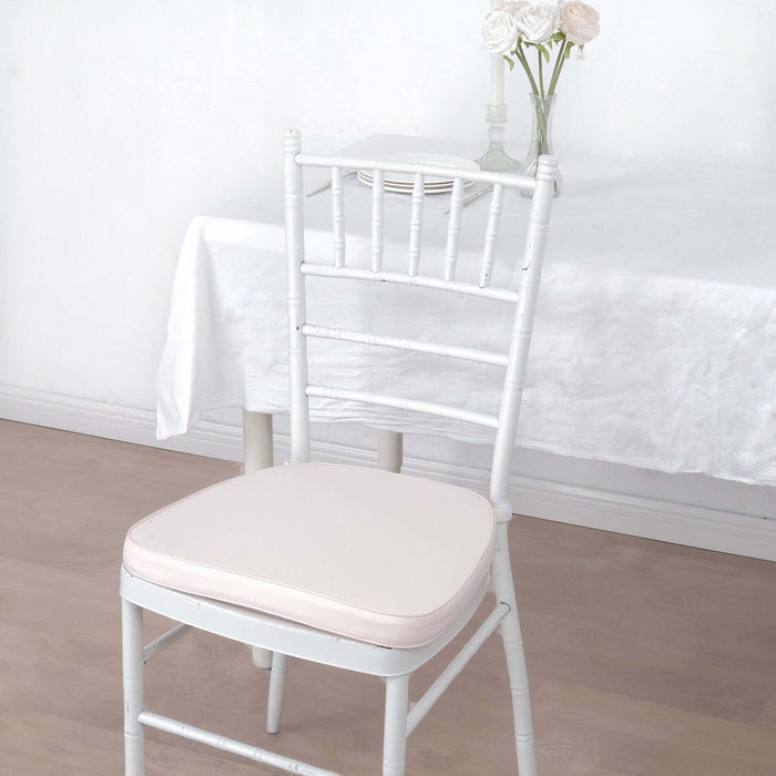 White chiavari chair with a cream cushion in a bright, minimalistic setting.