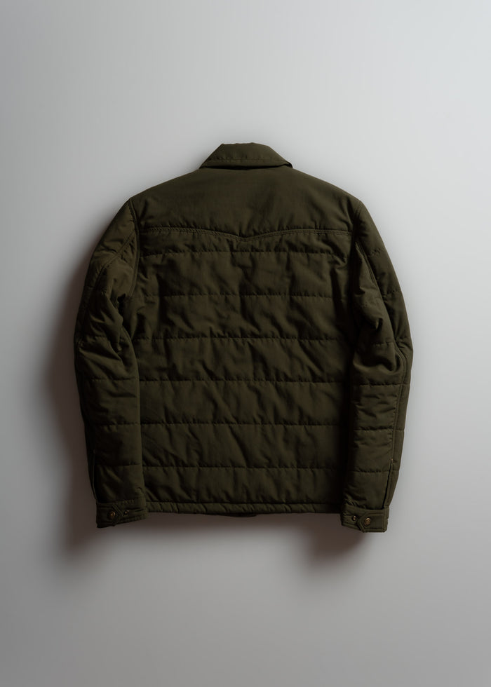 Olive green quilted jacket displayed on a light background, showcasing its back design and buttoned cuffs.