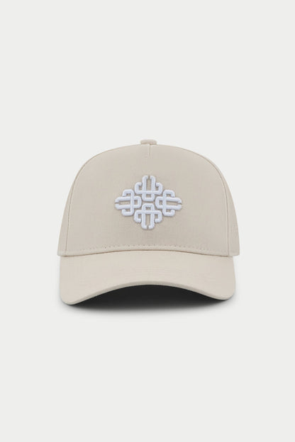 Beige cap with a white embroidered emblem logo on a white background