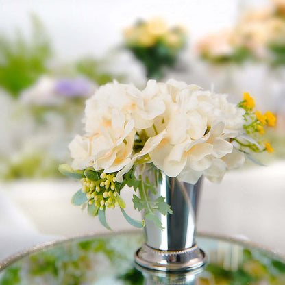 Silver vase with white and yellow artificial flowers