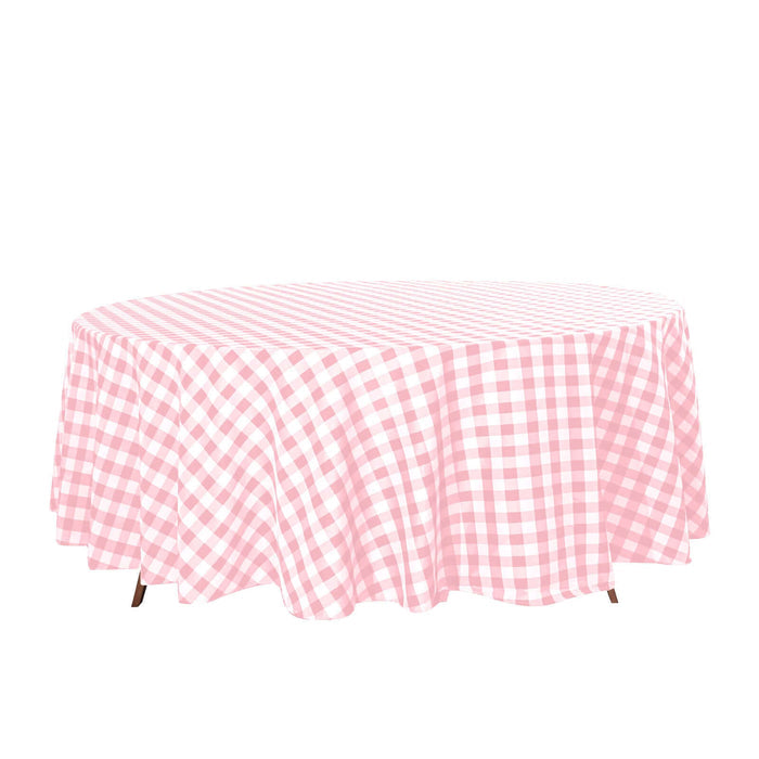Pink gingham round tablecloth on a white background