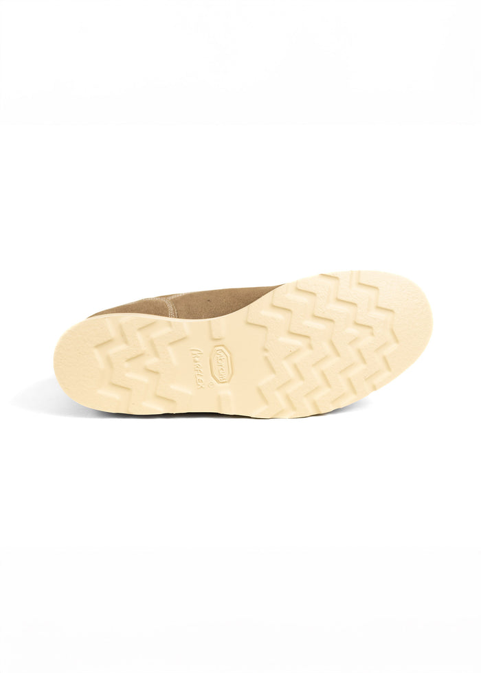 Tan shoe with a cream sole, featuring a zigzag tread pattern, displayed against a white background.
