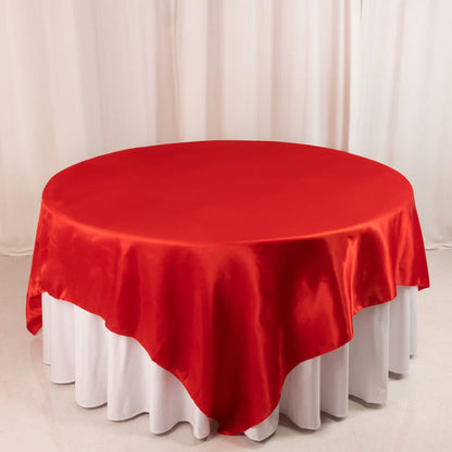 Red round tablecloth on a white table